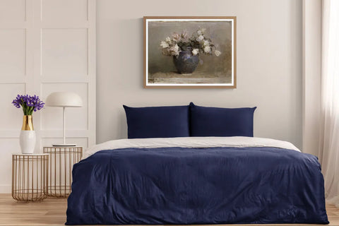 Abbott Handerson Thayer's Roses in a walnut frame above a bed with navy bedding