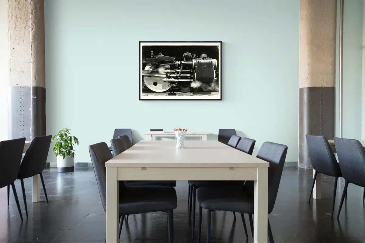 Charles Sheeler's Wheels framed in black above a boardroom table