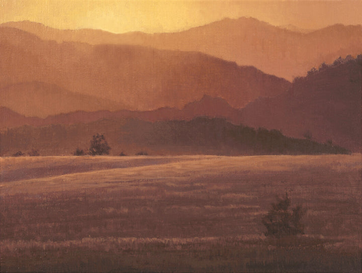 Layered mountains and valley rendered in warm burnt orange, amber, and brown tones beneath a hazy sunset sky.