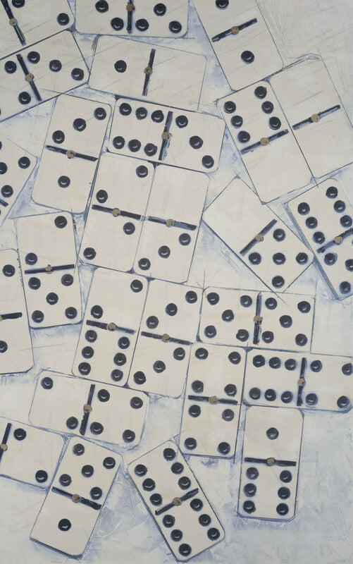 Scattered dominoes with black dots arranged on a white and pale blue background.