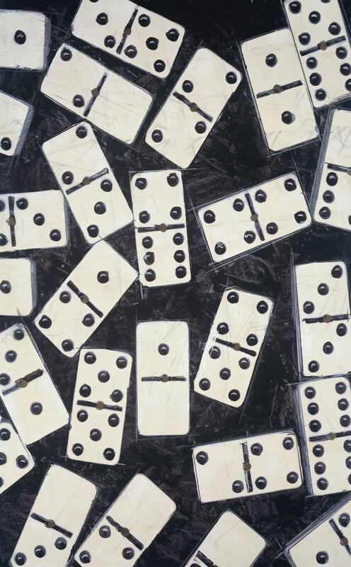 White dominoes with black dots scattered at various angles on a dark textured background.