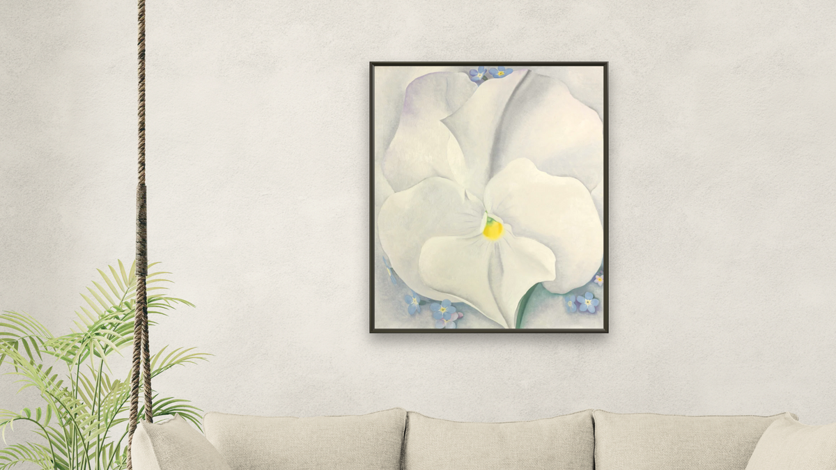 White Pansy by Georgia O'Keeffe, shown at 32 × 40 in (81.3 × 101.6 cm) on canvas in Ramino Satin Black, living