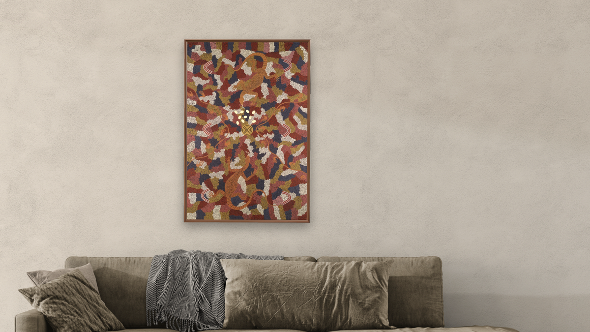 Goanna Dreaming by Clifford Possum Tjapaltjarri, shown at 28 × 42 in (71.1 × 106.7 cm) on canvas in Arber Warm Walnut, living