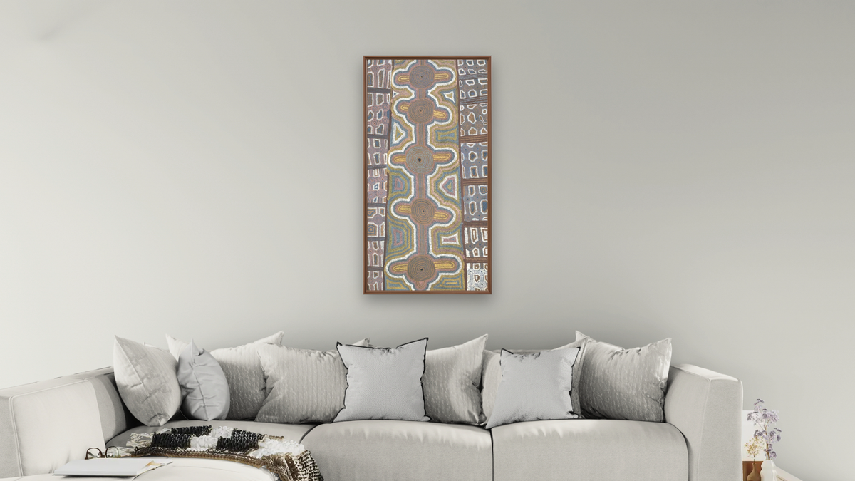 Kililingya by Uta Uta Tjangala, shown at 20 × 40 in (50.8 × 101.6 cm) on canvas in Arber Warm Walnut, living