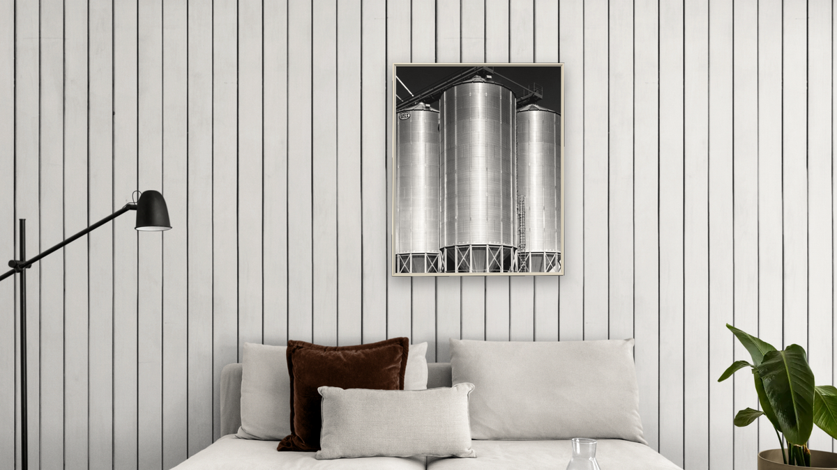 Corrugated Metal Silos #3 by Gordon Osmundson, shown at 32 × 40 in (81.3 × 101.6 cm) on canvas in Ramino Opaque White, living