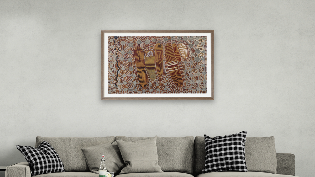 Old Man's Dreaming by Uta Uta Tjangala, shown at 28 × 42 in (71.1 × 106.7 cm) in Arber Light Walnut, living