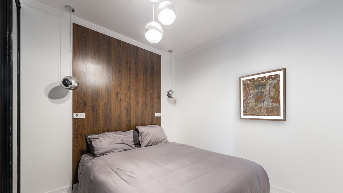 Warlugulong by Tim Leura Tjapaltjarri, shown at 32 × 32 in (81.3 × 81.3 cm) in Arber Light Walnut, bedroom