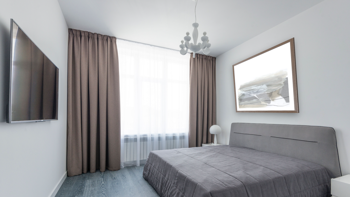 Nors by Dan Hobday, shown at 32 × 32 in (81.3 × 81.3 cm) in Arber Light Walnut, bedroom