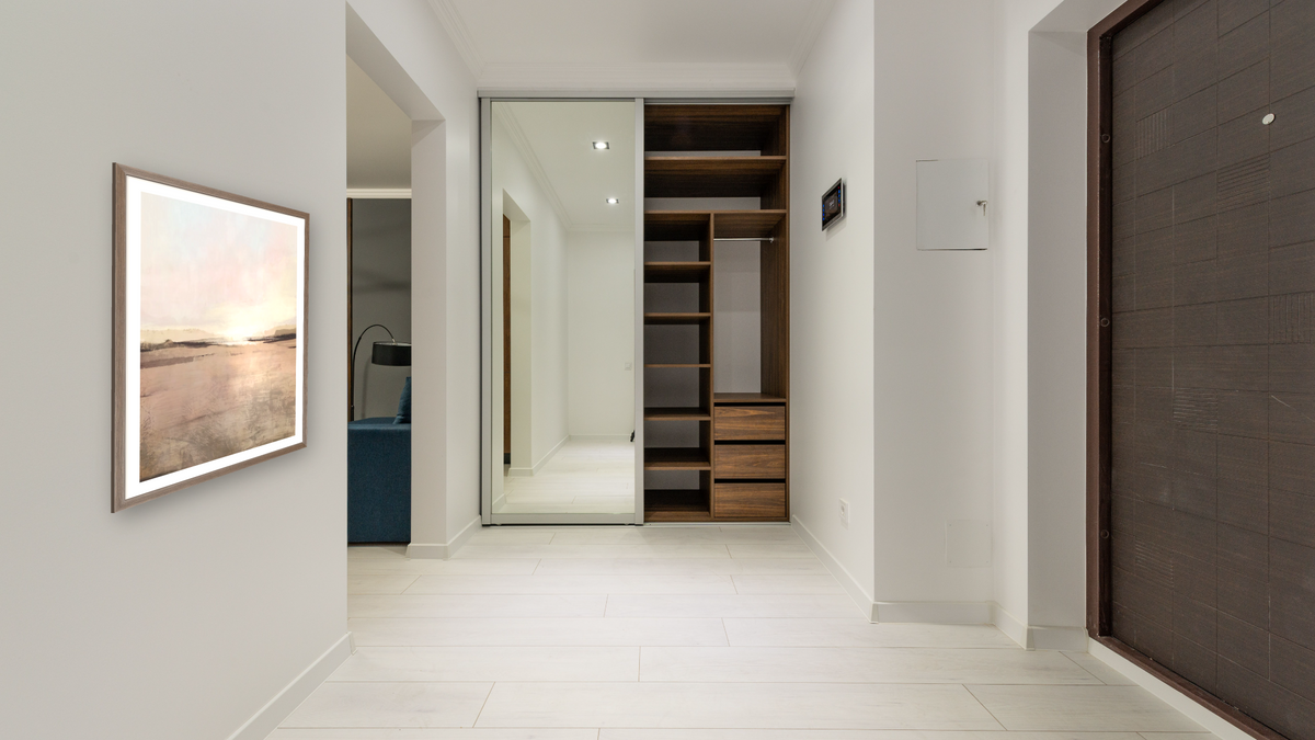 New Dawn by Dan Hobday, shown at 30 × 42 in (76.2 × 106.7 cm) in Arber Light Walnut, hallway