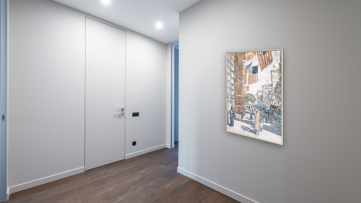 Flags, Fifth Avenue by Childe Hassam, shown at 28 × 42 in (71.1 × 106.7 cm) on canvas in Ramino Opaque White, hallway