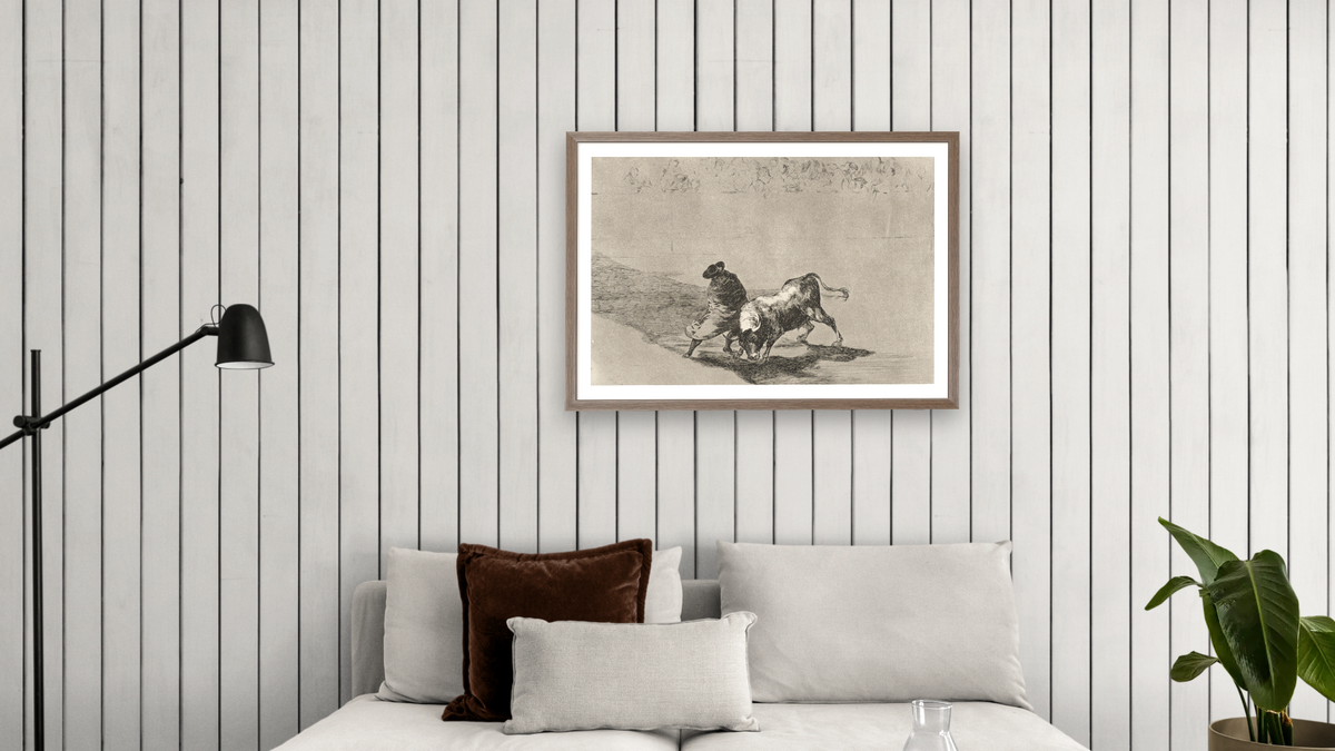 The Clever 'Student of Falces' Infuriates the Bull by Moving about Wrapped in his Cloak, Plate 14 from La Tauromaquia (The Art of Bullfighting) by Francisco de Goya, shown at 28 × 42 in (71.1 × 106.7 cm) in Arber Light Walnut, living
