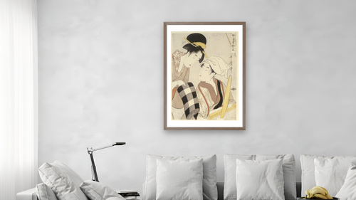 A half-length portrait of two women, one seated at a loom and the other showing a roll of black and white checkered cloth by Kitagawa Utamaro, shown at 28 × 42 in (71.1 × 106.7 cm) in Arber Light Walnut, living [arteriel-render:v6:room_b:28x42@57,38]