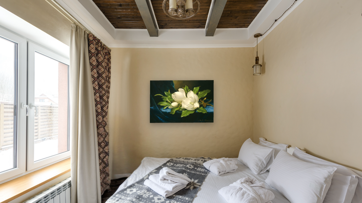 Giant Magnolias on a Blue Velvet Cloth by Martin Johnson Heade, shown at 28 × 42 in (71.1 × 106.7 cm) as gallery-wrapped canvas, hotel guest room