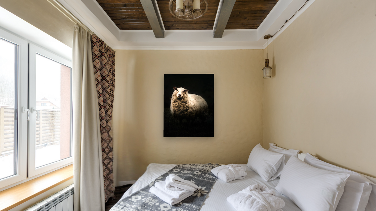 NRBB sheep by Brandon Luther, shown at 32 × 40 in (81.3 × 101.6 cm) as gallery-wrapped canvas, hotel guest room