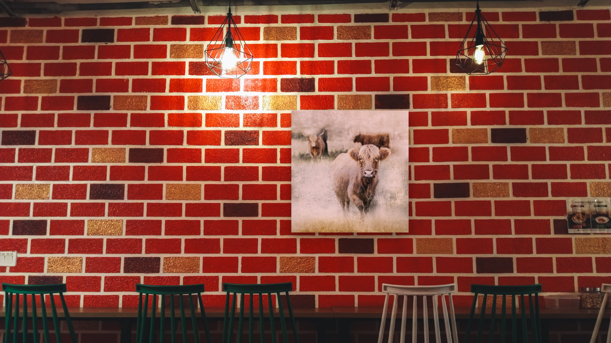 New Friend by Brandon Luther, shown at 32 × 32 in (81.3 × 81.3 cm) as gallery-wrapped canvas, restaurant