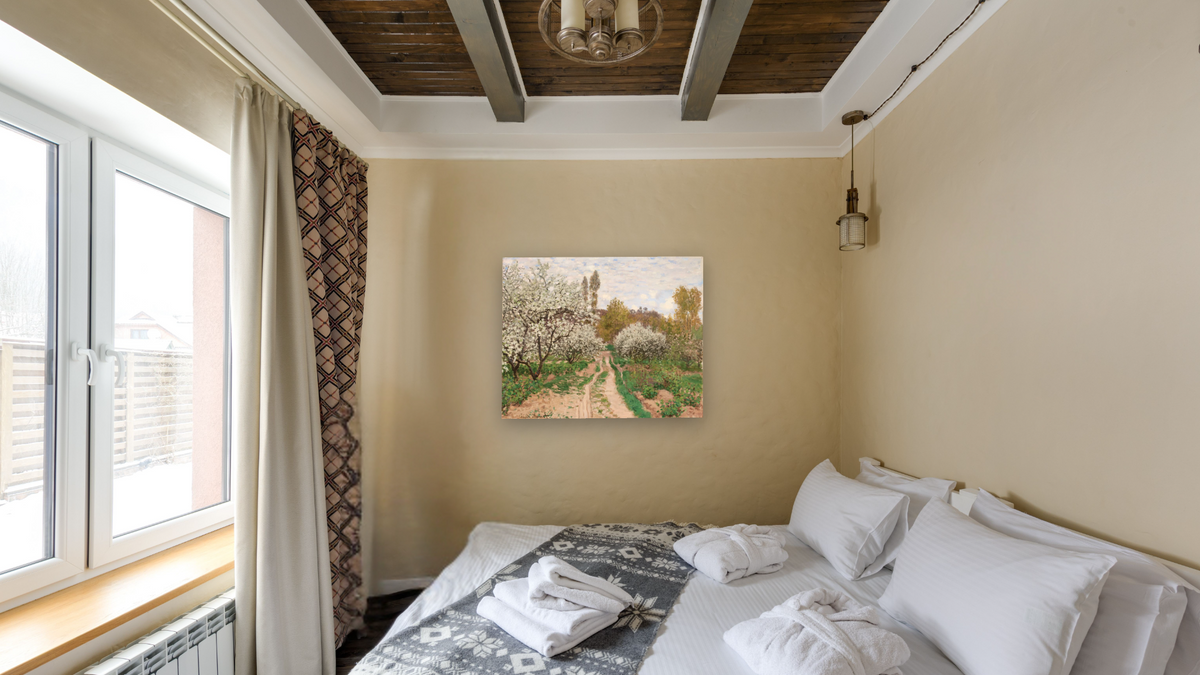 Apple Trees in Blossom by Claude Monet, shown at 32 × 40 in (81.3 × 101.6 cm) as gallery-wrapped canvas, hotel guest room