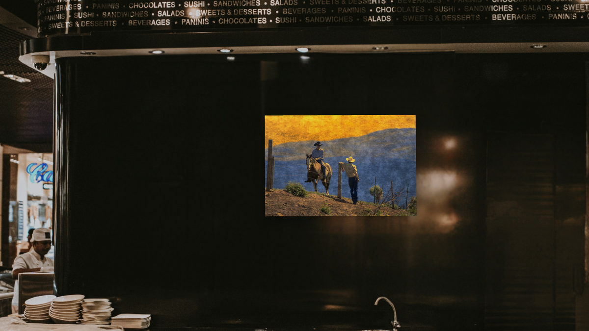 Cowboys by Doug Landreth, shown at 28 × 42 in (71.1 × 106.7 cm) as gallery-wrapped canvas, restaurant