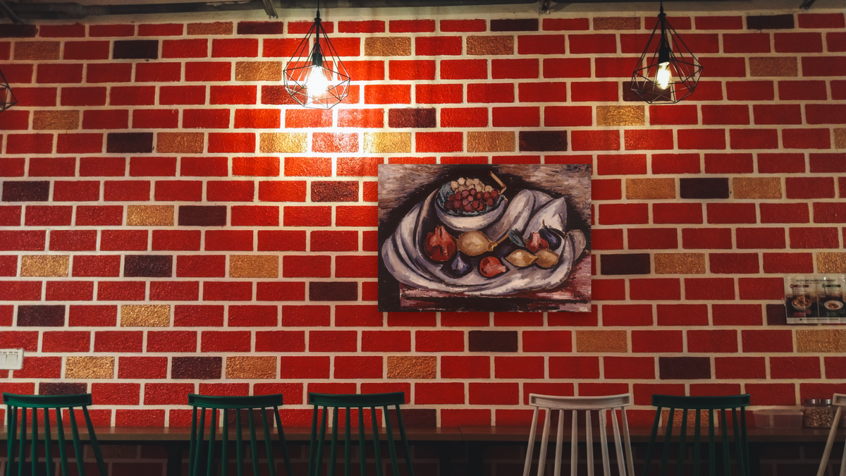 Still Life with Compote and Fruit by Marsden Hartley, shown at 28 × 42 in (71.1 × 106.7 cm) as gallery-wrapped canvas, restaurant