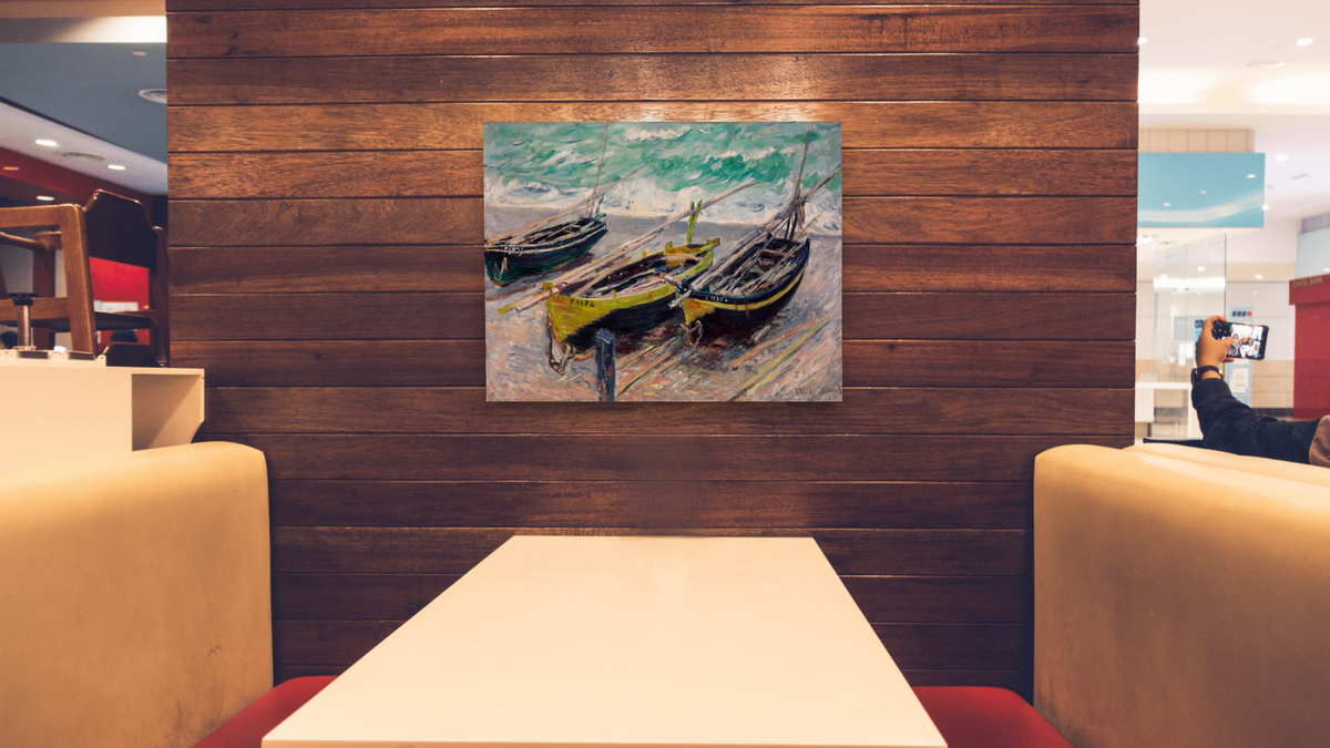 Three Fishing Boats by Claude Monet, shown at 32 × 40 in (81.3 × 101.6 cm) as gallery-wrapped canvas, restaurant