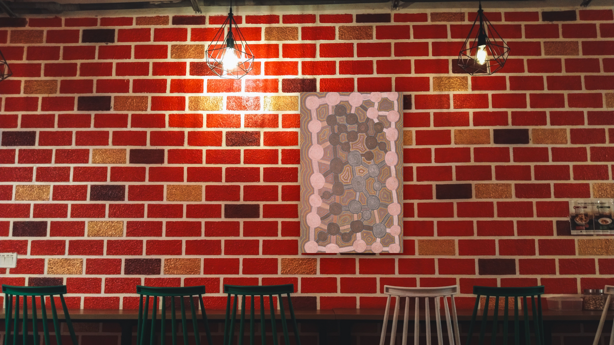 Tingari Myth by Yala Yala Gibbes, shown at 28 × 42 in (71.1 × 106.7 cm) as gallery-wrapped canvas, restaurant