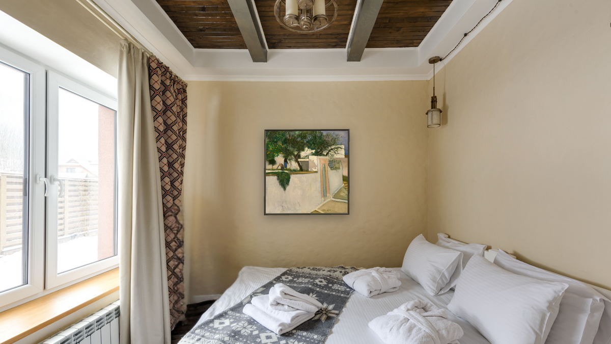 Les Dames Dans Leur Jardin (Patmos) by René Genis, shown at 32 × 32 in (81.3 × 81.3 cm) on canvas in Ramino Satin Black, hotel guest room