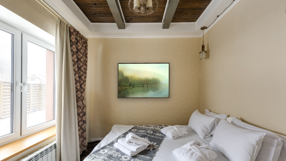 Fishing at Dawn by Kirsten Söderlind, shown at 28 × 42 in (71.1 × 106.7 cm) on canvas in Ramino Satin Black, hotel guest room
