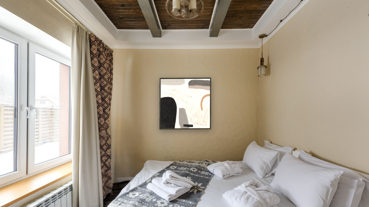 Drop by Dan Hobday, shown at 32 × 32 in (81.3 × 81.3 cm) on canvas in Ramino Satin Black, hotel guest room
