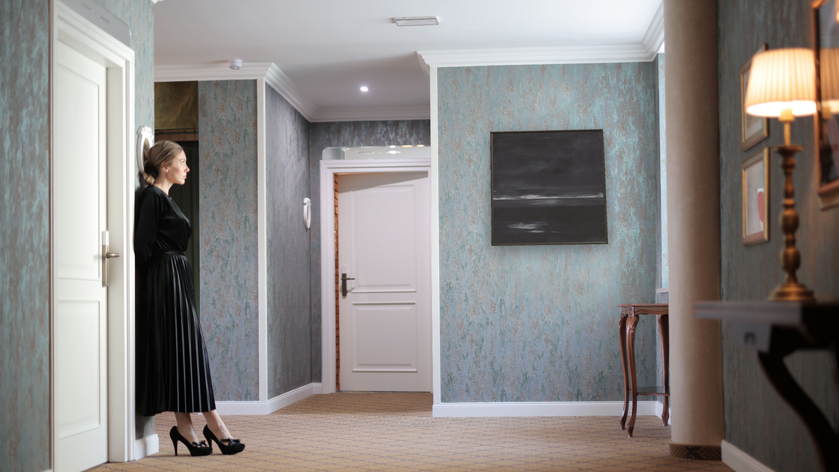 LS No. 245 by Brandon McKenzie, shown at 32 × 32 in (81.3 × 81.3 cm) on canvas in Ramino Satin Black, hotel lobby