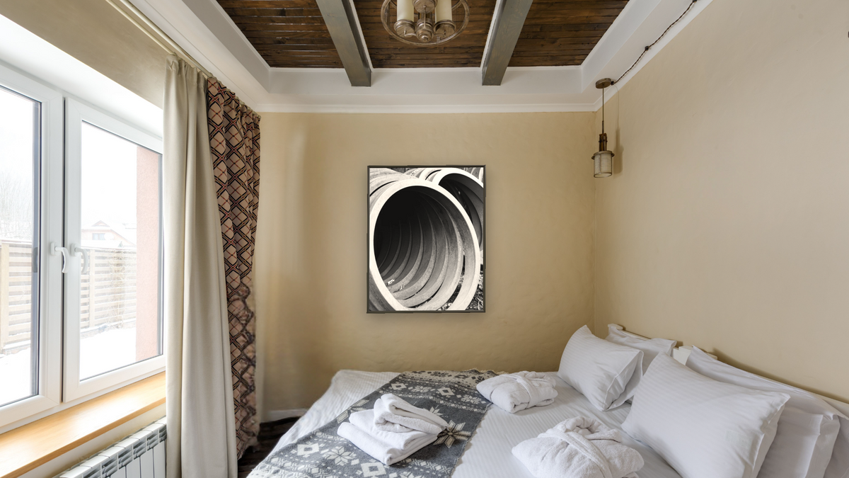 Locomotive Tires by Gordon Osmundson, shown at 32 × 40 in (81.3 × 101.6 cm) on canvas in Ramino Satin Black, hotel guest room