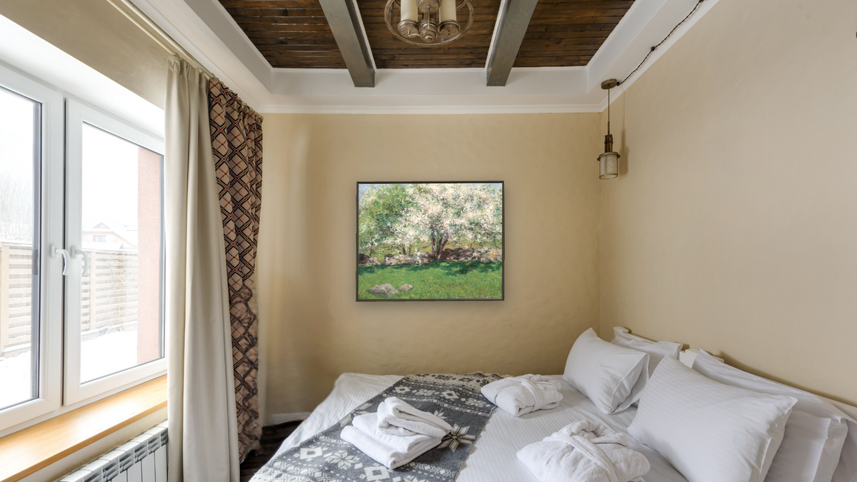 Apple Trees by John Leslie Breck, shown at 32 × 40 in (81.3 × 101.6 cm) on canvas in Ramino Satin Black, hotel guest room
