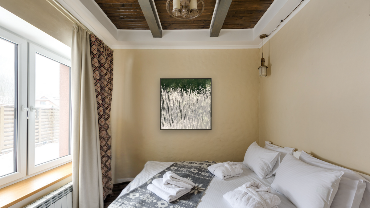 The Icicle Forest by Judith Rayl, shown at 32 × 32 in (81.3 × 81.3 cm) on canvas in Ramino Satin Black, hotel guest room