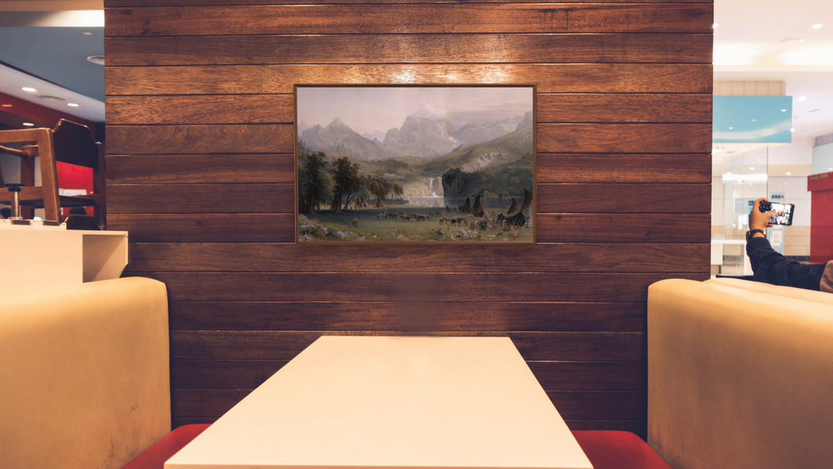 The Rocky Mountains, Lander's Peak by Albert Bierstadt, shown at 28 × 42 in (71.1 × 106.7 cm) on canvas in Arber Warm Walnut, restaurant