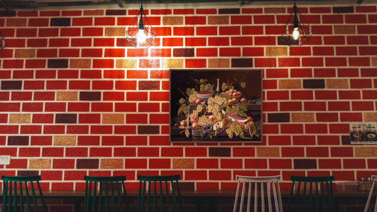 Still Life with Fruit and Champagne by Severin Roesen, shown at 30 × 40 in (76.2 × 101.6 cm) on canvas in Arber Warm Walnut, restaurant
