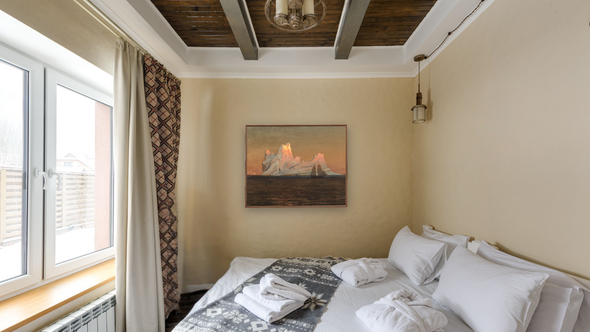 The Iceberg by Frederic Edwin Church, shown at 32 × 40 in (81.3 × 101.6 cm) on canvas in Arber Warm Walnut, hotel guest room