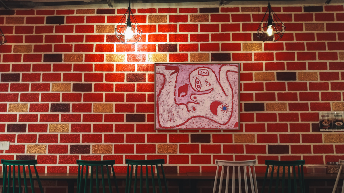 A Woman For Gods by Paul Klee, shown at 30 × 40 in (76.2 × 101.6 cm) on canvas in Arber Warm Walnut, restaurant