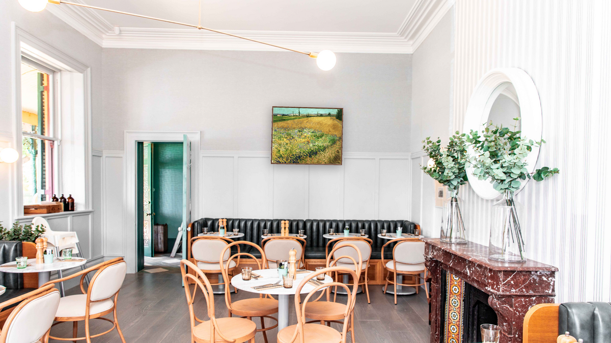 Wheatfield by Vincent van Gogh, shown at 32 × 40 in (81.3 × 101.6 cm) on canvas in Arber Warm Walnut, restaurant