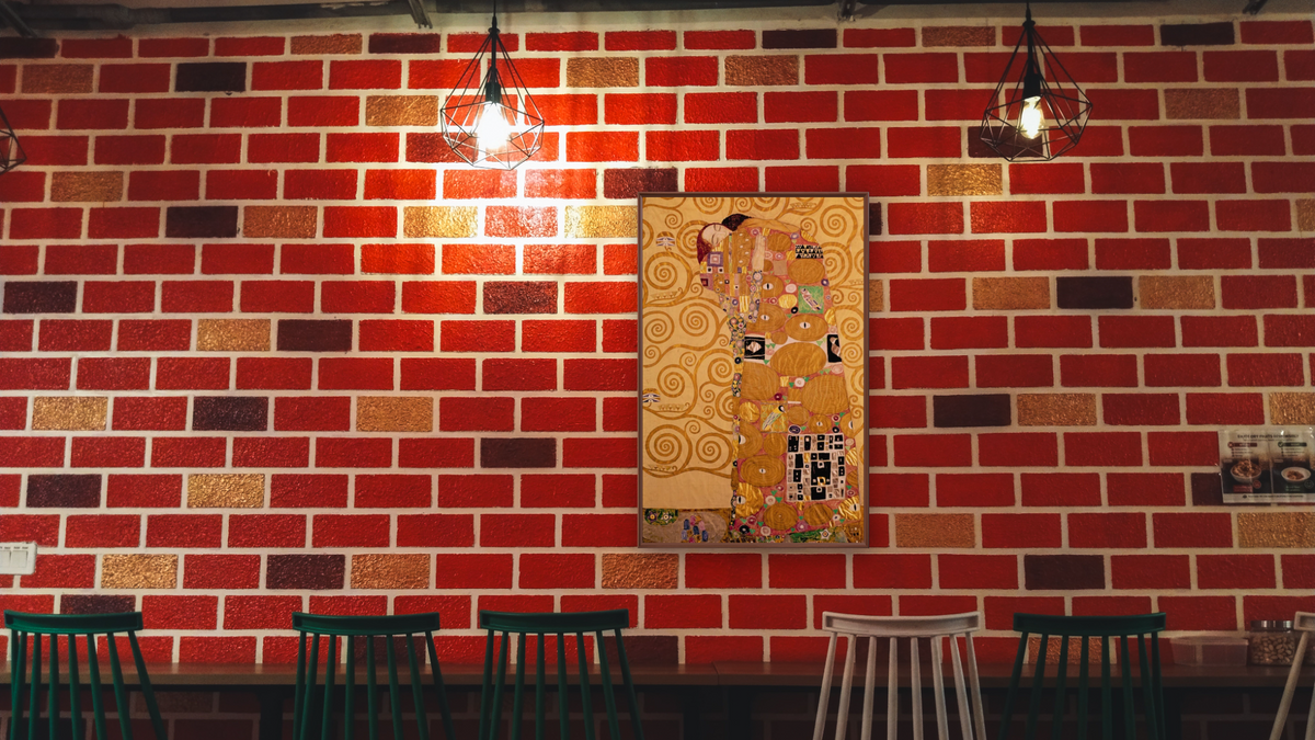 Fulfilment (Stoclet Frieze) by Gustav Klimt, shown at 28 × 42 in (71.1 × 106.7 cm) on canvas in Arber Warm Walnut, restaurant