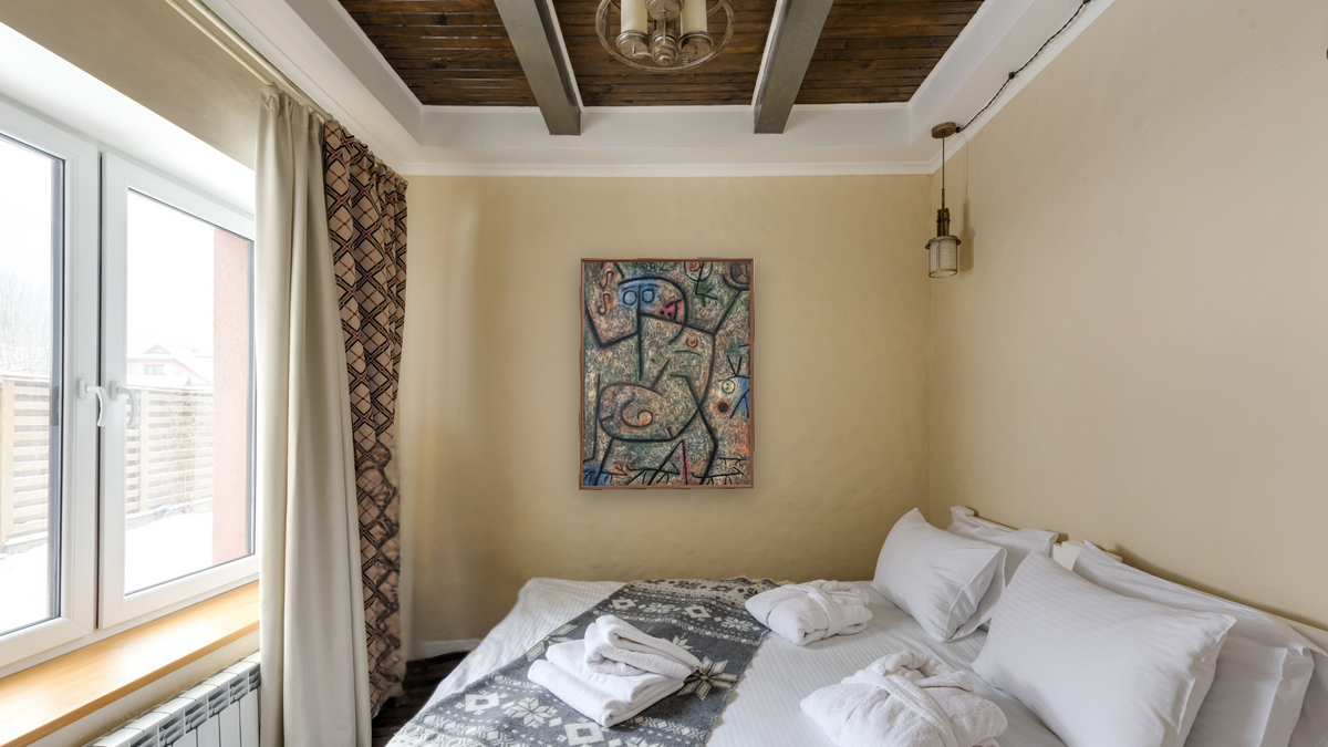 Oh! These Rumors! by Paul Klee, shown at 30 × 40 in (76.2 × 101.6 cm) on canvas in Arber Warm Walnut, hotel guest room