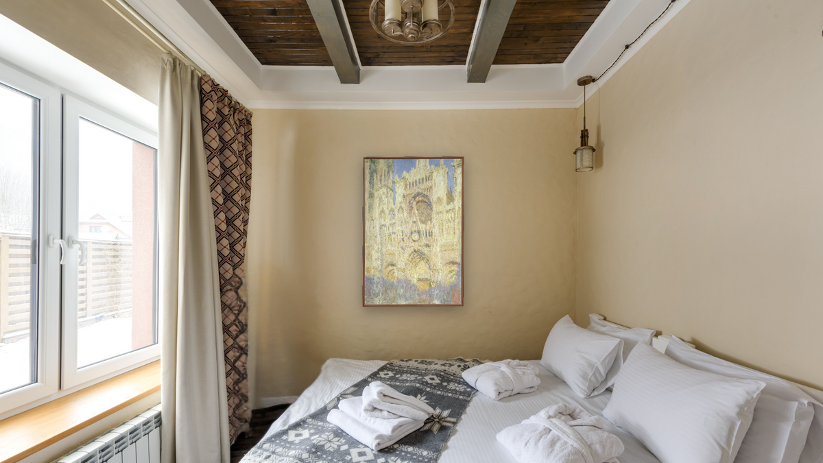 Rouen Cathedral at Sunset by Claude Monet, shown at 28 × 42 in (71.1 × 106.7 cm) on canvas in Arber Warm Walnut, hotel guest room