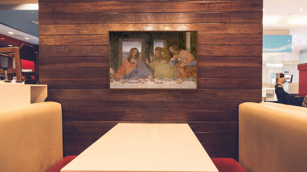 The Last Supper by Leonardo da Vinci, shown at 28 × 42 in (71.1 × 106.7 cm) on canvas in Arber Warm Walnut, restaurant
