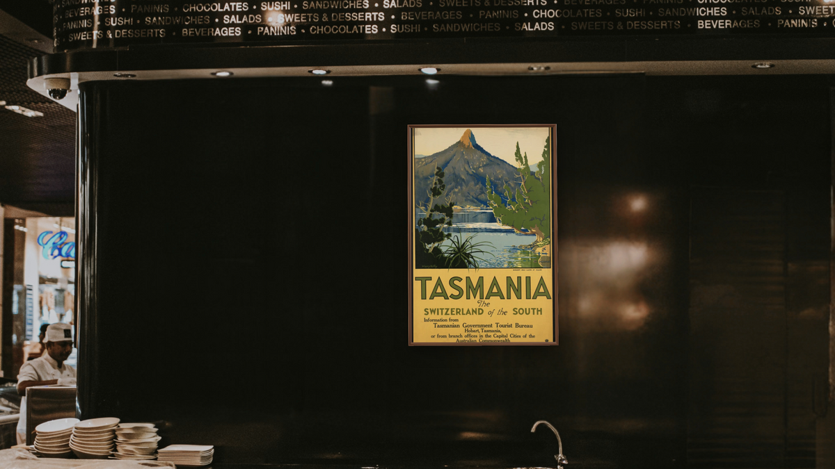 BPL Travel Posters, shown at 28 × 42 in (71.1 × 106.7 cm) on canvas in Arber Warm Walnut, restaurant