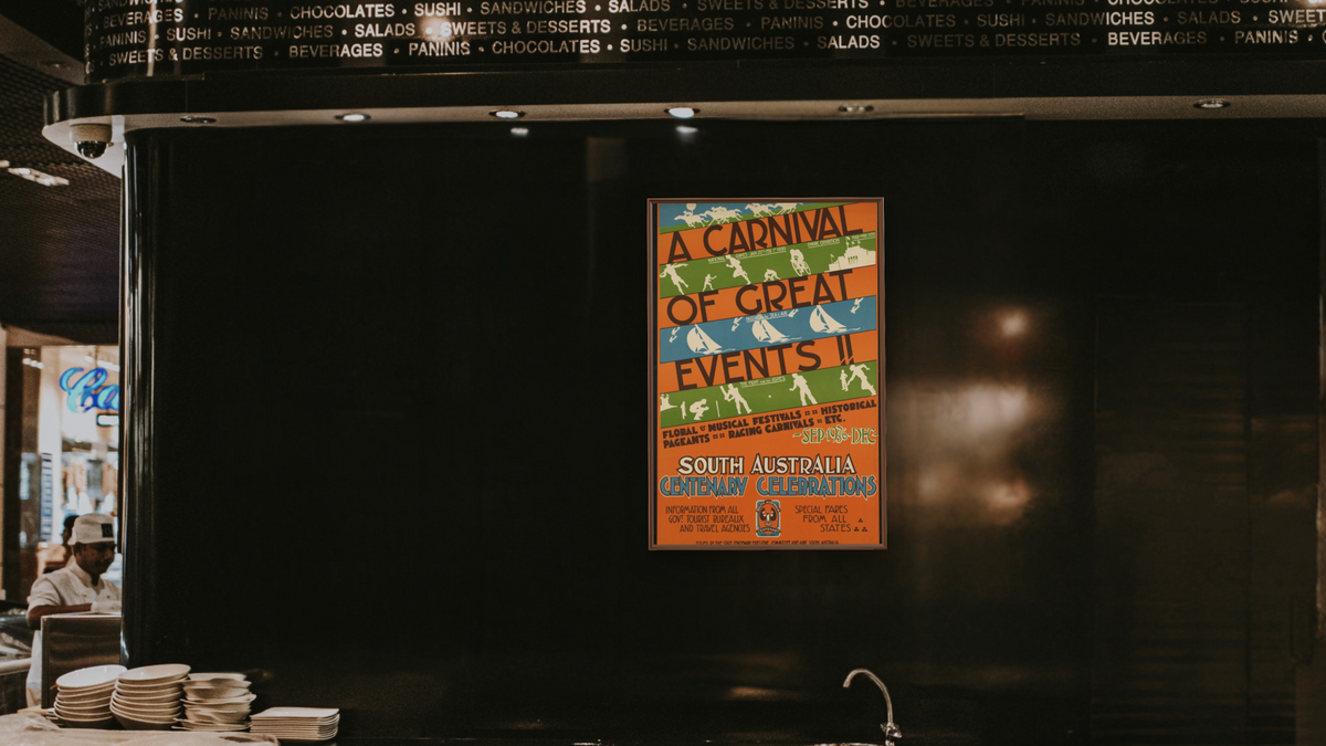 BPL Travel Posters, shown at 28 × 42 in (71.1 × 106.7 cm) on canvas in Arber Warm Walnut, restaurant