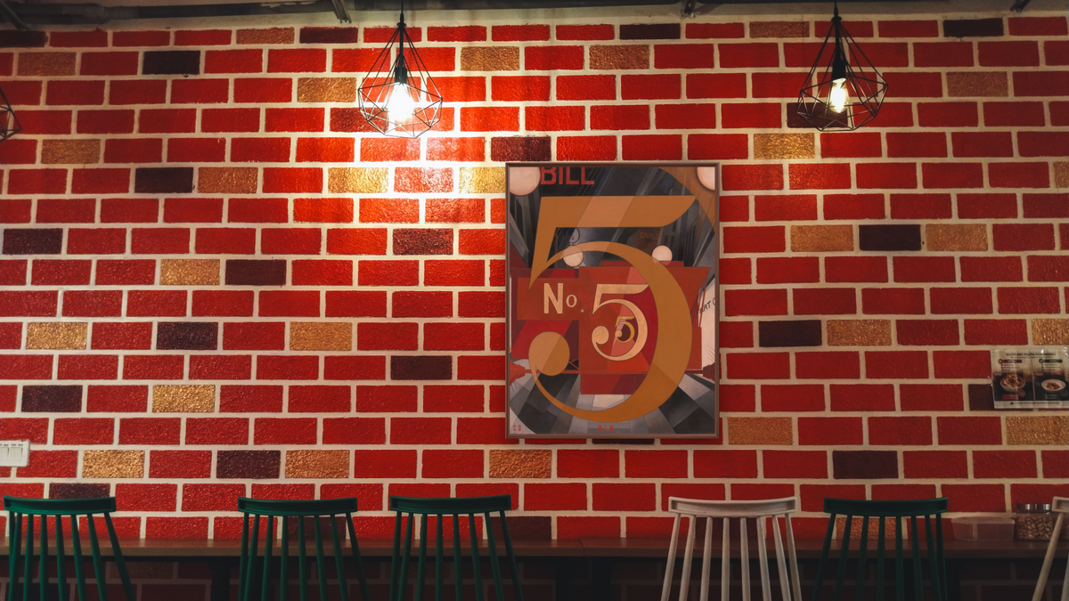 I Saw the Figure 5 in Gold by Charles Demuth, shown at 32 × 40 in (81.3 × 101.6 cm) on canvas in Arber Warm Walnut, restaurant