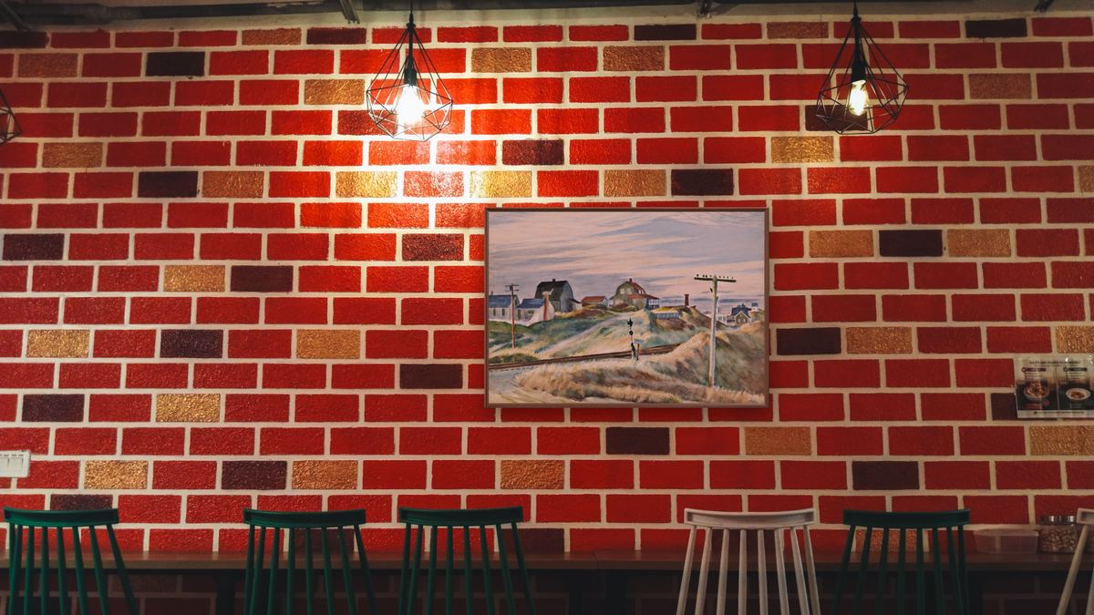 Cottages at North Truro by Edward Hopper, shown at 28 × 42 in (71.1 × 106.7 cm) on canvas in Arber Warm Walnut, restaurant