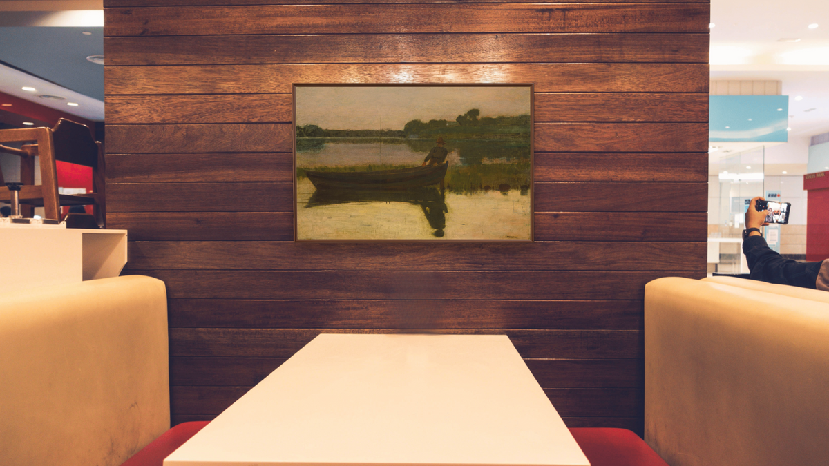 Sunset by Winslow Homer, shown at 28 × 42 in (71.1 × 106.7 cm) on canvas in Arber Warm Walnut, restaurant