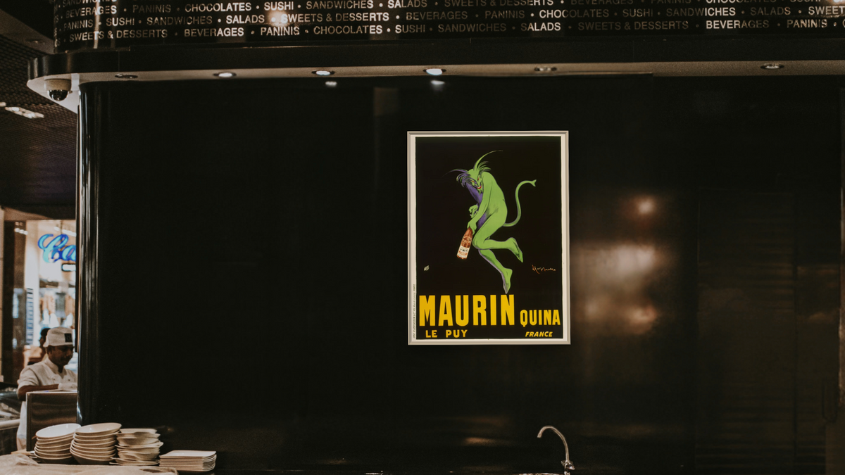Maurin Quina by Leonetto Cappiello, shown at 30 × 40 in (76.2 × 101.6 cm) on canvas in Ramino Opaque White, restaurant