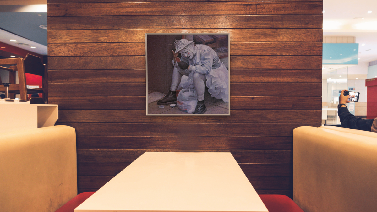 Scottish Clown by Kirsten Söderlind, shown at 32 × 32 in (81.3 × 81.3 cm) on canvas in Ramino Opaque White, restaurant