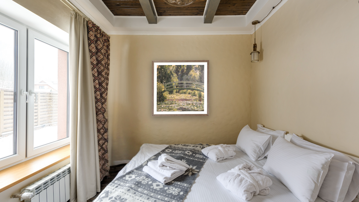 The Japanese Footbridge, Giverny by Claude Monet, shown at 31 × 32 in (78.7 × 81.3 cm) in Arber Light Walnut, hotel guest room