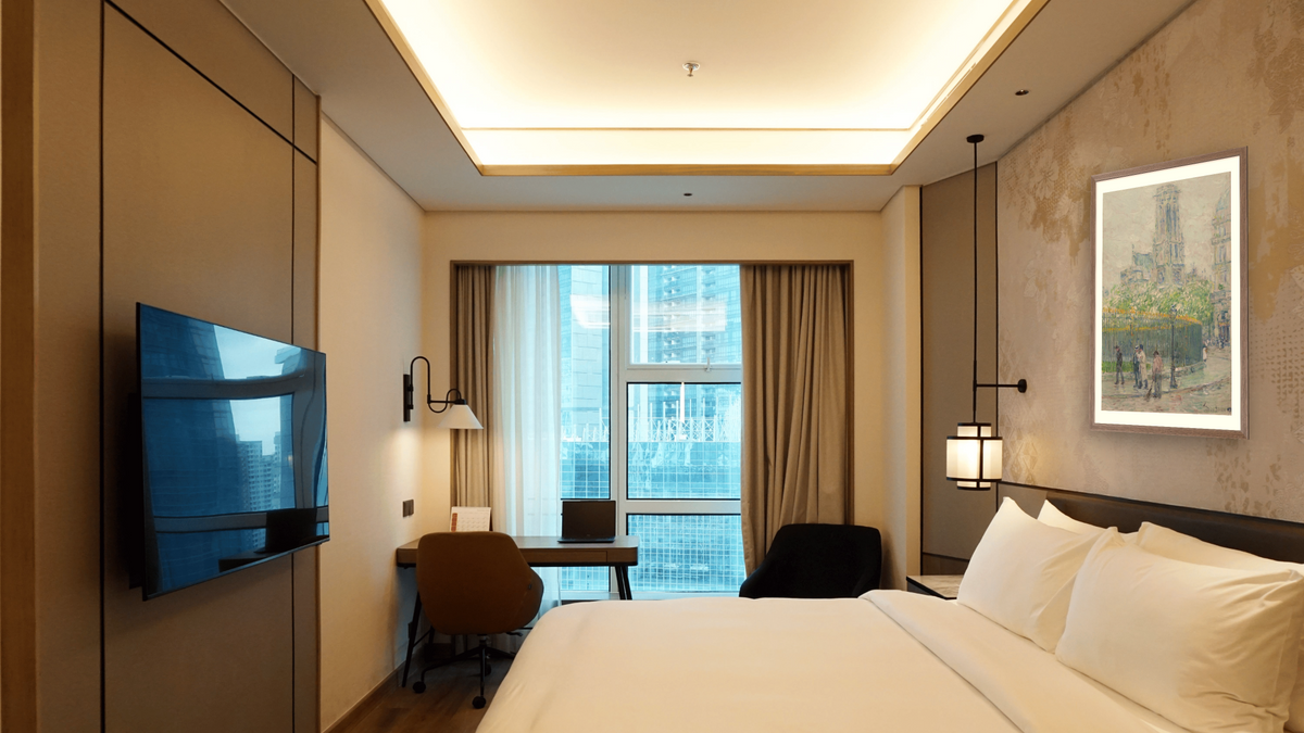 St. Germain l’Auxerrois by Childe Hassam, shown at 28 × 42 in (71.1 × 106.7 cm) in Arber Light Walnut, hotel guest room