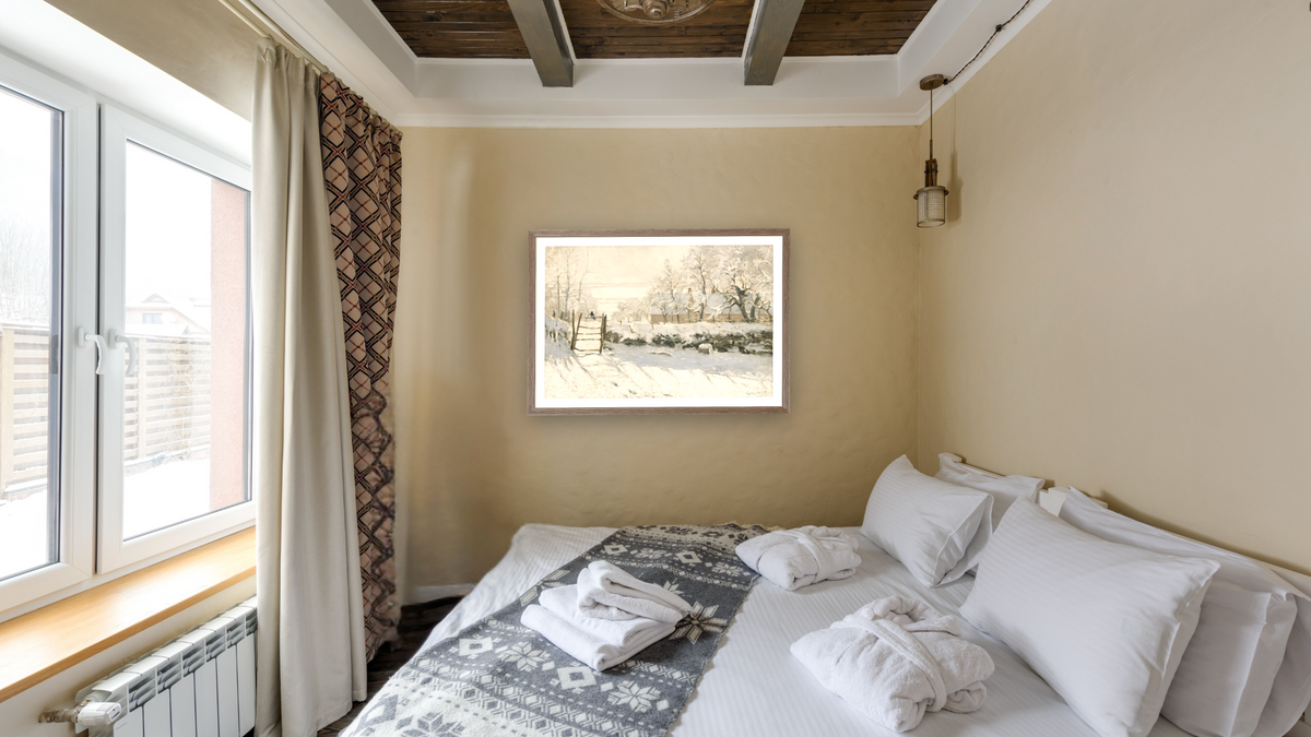 The Magpie by Claude Monet, shown at 28 × 42 in (71.1 × 106.7 cm) in Arber Light Walnut, hotel guest room